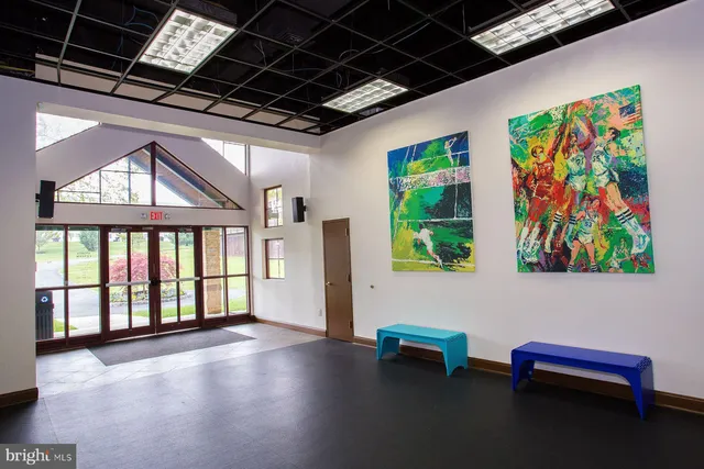 a dining room with furniture a floor to ceiling window and a table