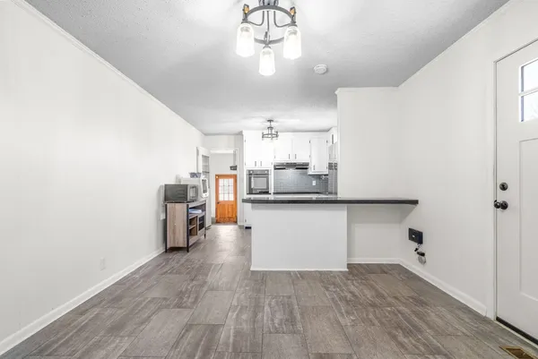 a kitchen with a refrigerator and countertop cabinets