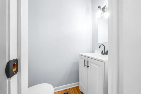 a bathroom with a sink a toilet and mirror