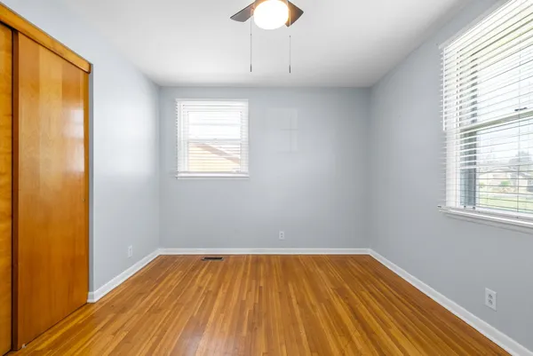 a view of a room with wooden floor and a window