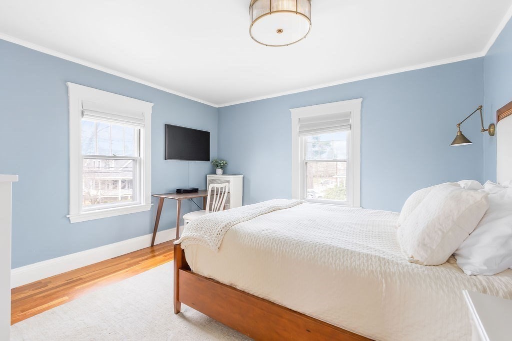 62 Grant Street Needham, MA 02492 - Photo 13 of 24 a bedroom with a bed flat screen tv and window