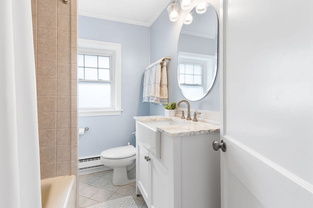 62 Grant Street Needham, MA 02492 - Photo 16 of 24 a bathroom with a sink toilet and a mirror