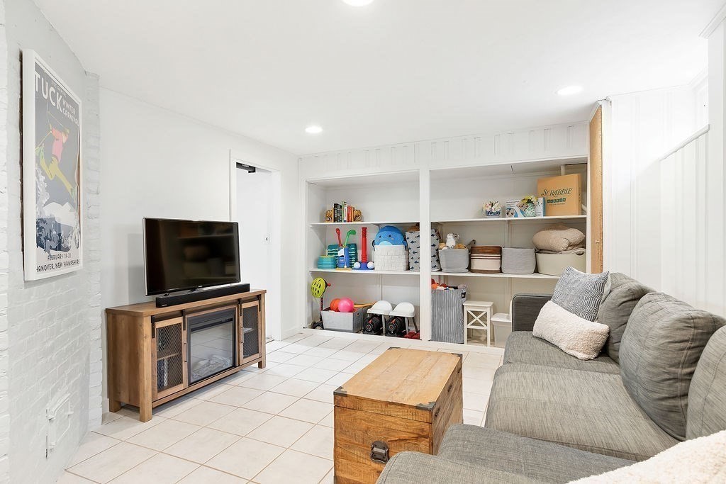 62 Grant Street Needham, MA 02492 - Photo 18 of 24 a living room with furniture and a flat screen tv