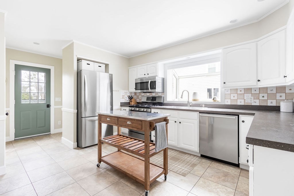 62 Grant Street Needham, MA 02492 - Photo 6 of 24 a kitchen with stainless steel appliances granite countertop a refrigerator and a stove top oven