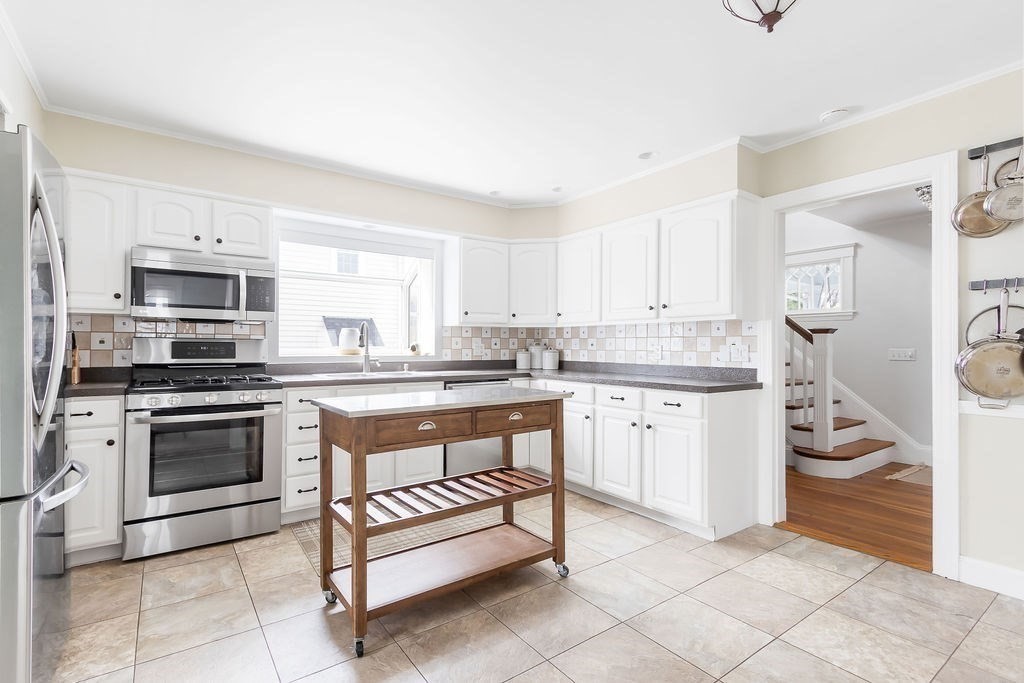 62 Grant Street Needham, MA 02492 - Photo 7 of 24 a kitchen with a sink stove and white cabinets