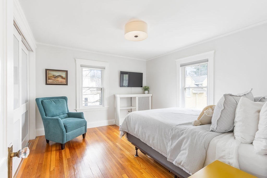 62 Grant Street Needham, MA 02492 - Photo 10 of 24 a bedroom with a bed and furniture with wooden floor