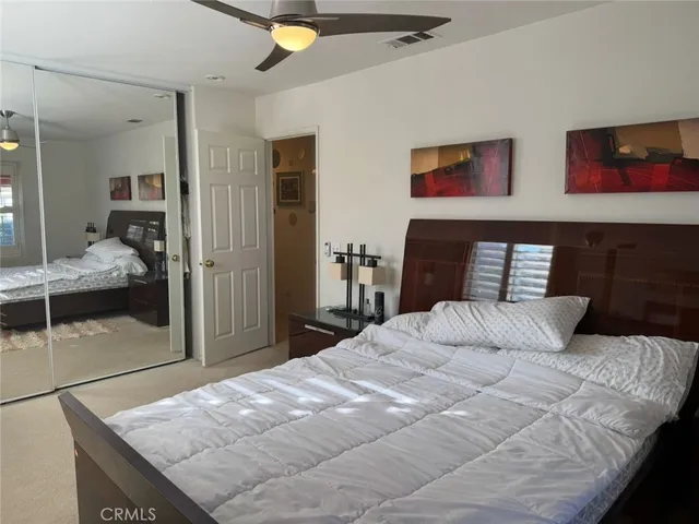 a bedroom with a bed and walk in closet
