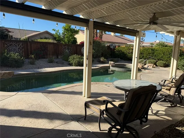 a patio with yard glass top table and chairs