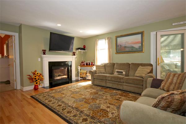 9 Penelope Road Bourne, MA 02532 - Photo 7 of 28 a living room with furniture a flat screen tv and a fireplace