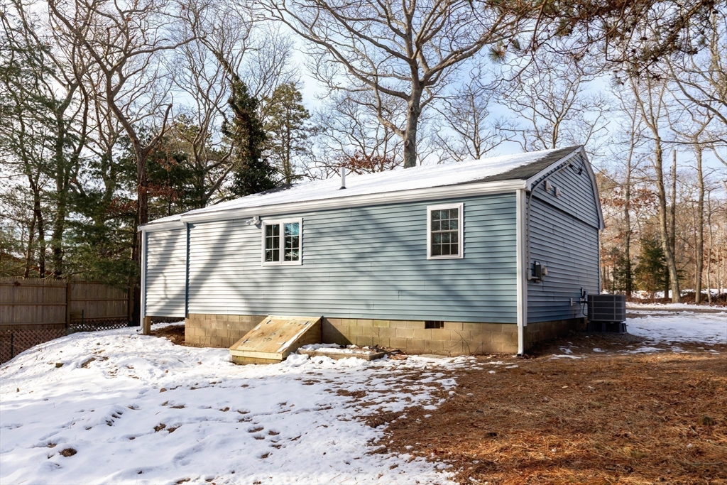 2 Womponoag Road Plymouth, MA 02360 - Photo 23 of 24 a front view of a house with a yard covered in snow