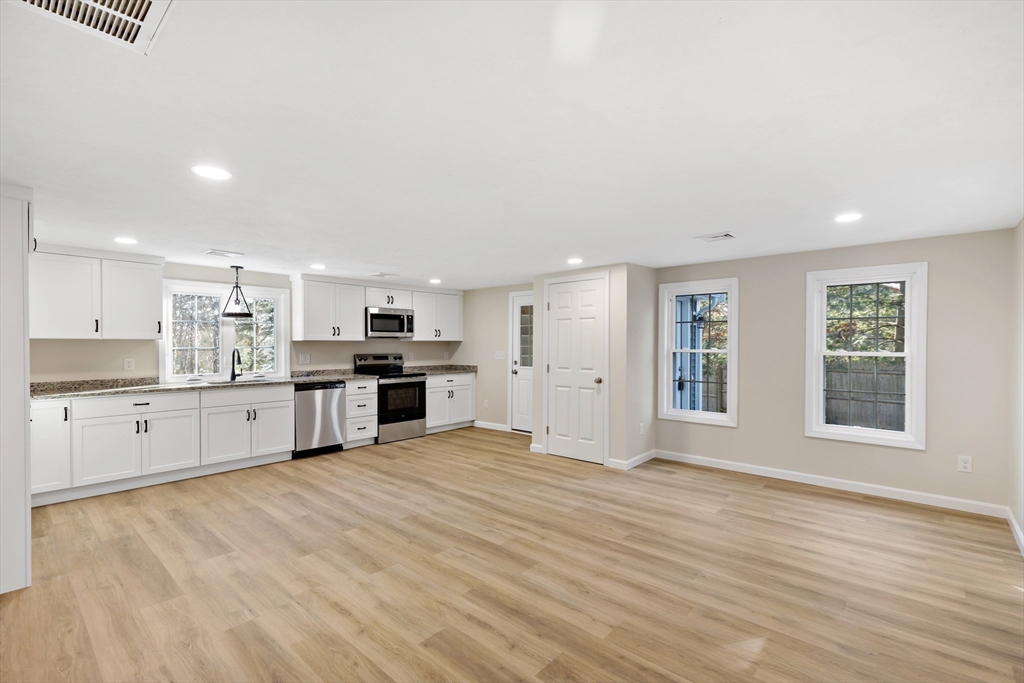 2 Womponoag Road Plymouth, MA 02360 - Photo 8 of 24 a large kitchen with kitchen island a stove a sink dishwasher and a oven with white cabinets