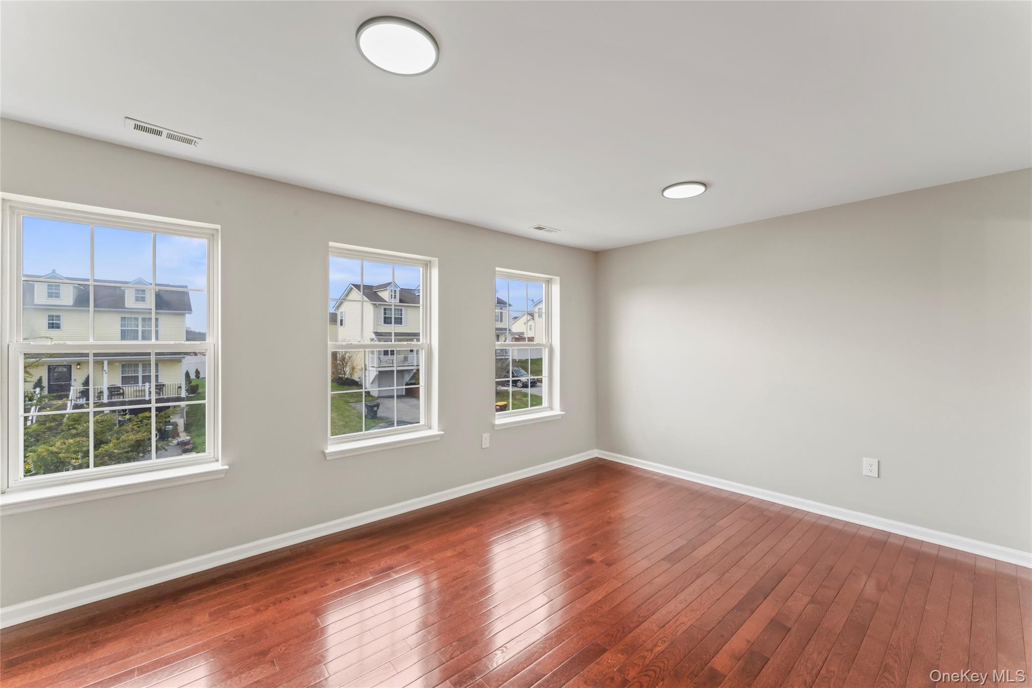 99 Evan Road Warwick, NY 10990 - Photo 13 of 27 a view of an empty room with wooden floor and a window