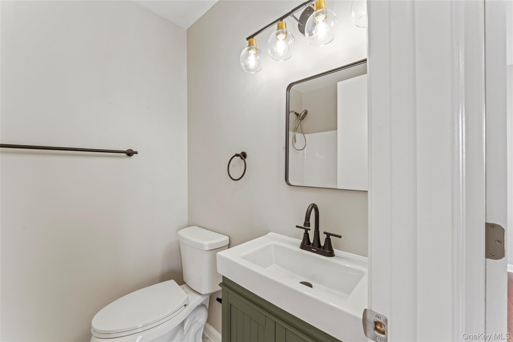 99 Evan Road Warwick, NY 10990 - Photo 19 of 27 a bathroom with a sink mirror and toilet