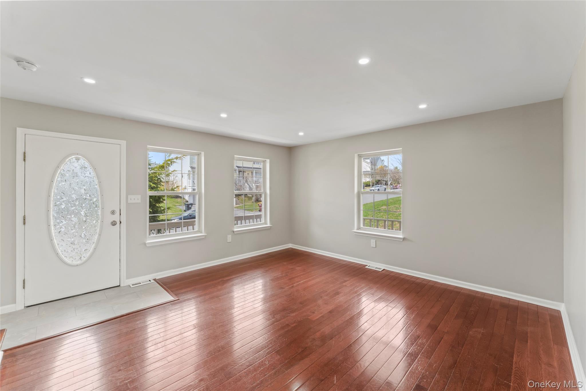 99 Evan Road Warwick, NY 10990 - Photo 3 of 27 a view of an empty room with wooden floor and a window