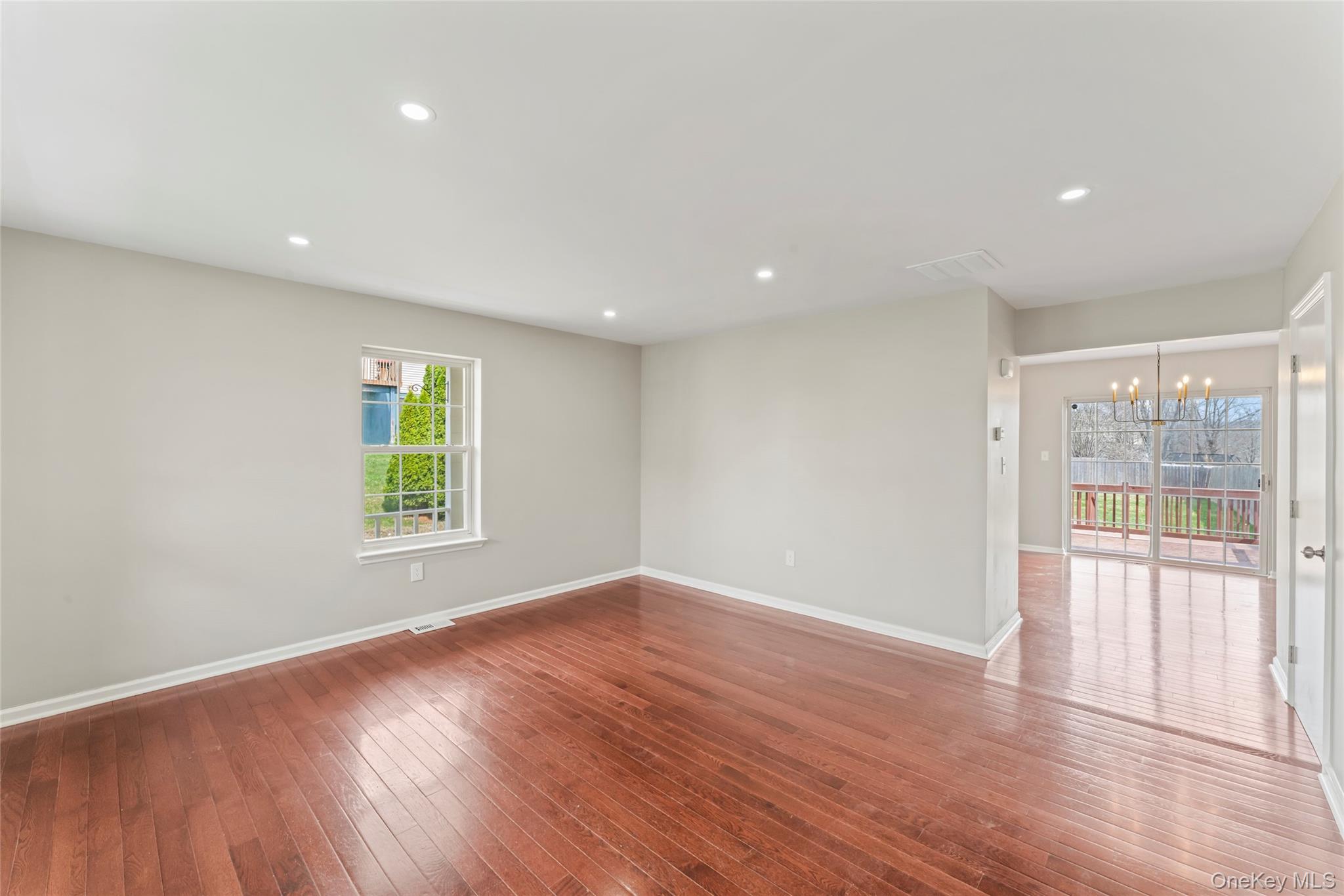 99 Evan Road Warwick, NY 10990 - Photo 5 of 27 an empty room with wooden floor and windows