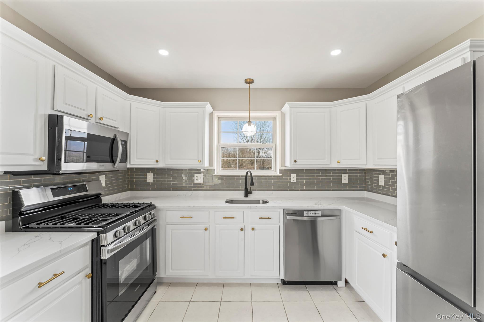99 Evan Road Warwick, NY 10990 - Photo 8 of 27 a kitchen with white cabinets stainless steel appliances and sink