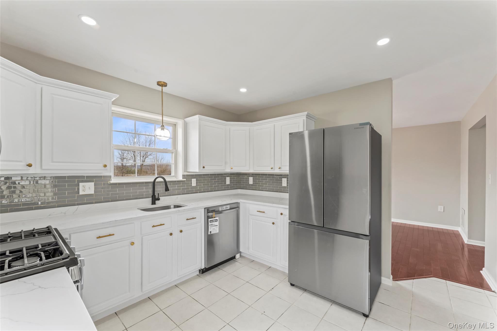 99 Evan Road Warwick, NY 10990 - Photo 9 of 27 a kitchen with a sink appliances and cabinets