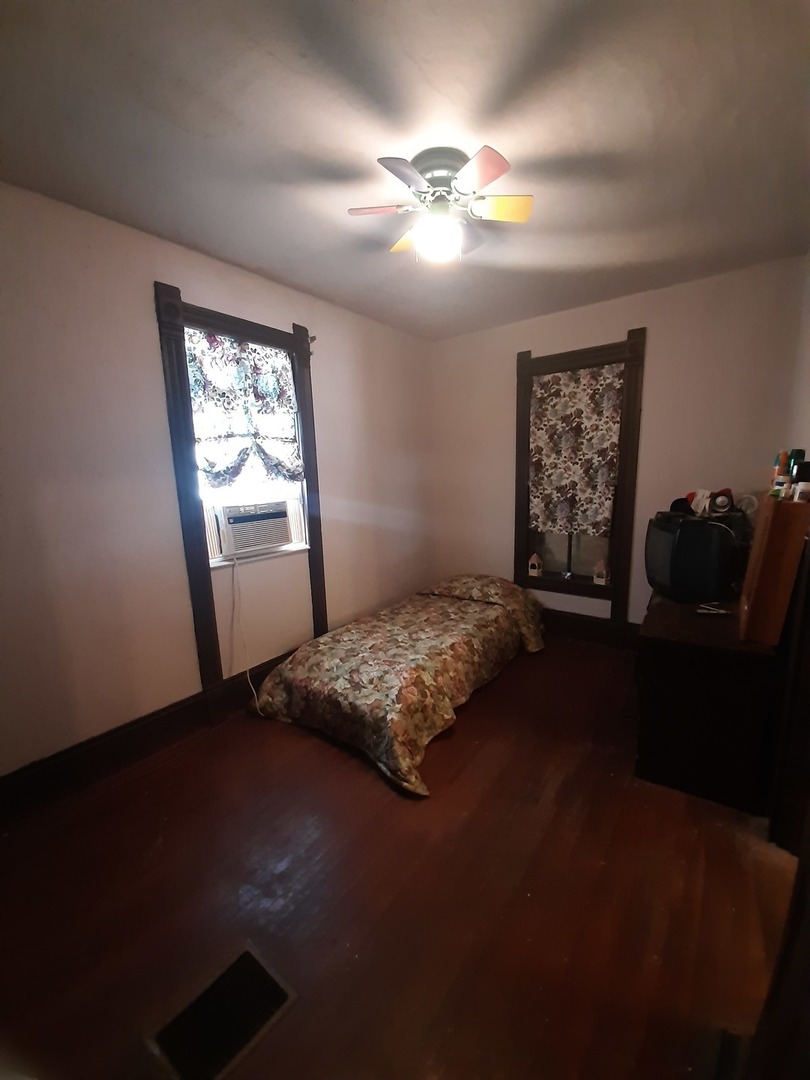 1402 South Wright Street Bloomington, IL 61701 - Photo 13 of 20 a bed sitting in a bedroom next to a window