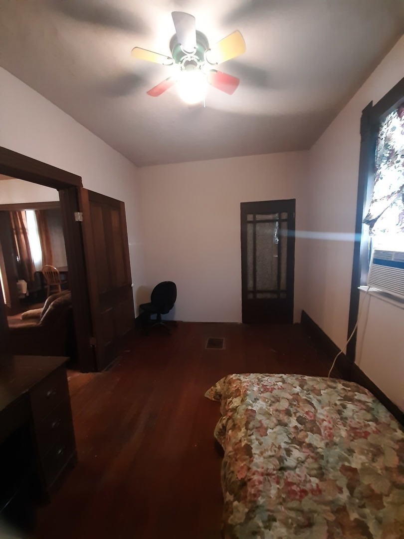 1402 South Wright Street Bloomington, IL 61701 - Photo 14 of 20 a bedroom with a bed and a chandelier