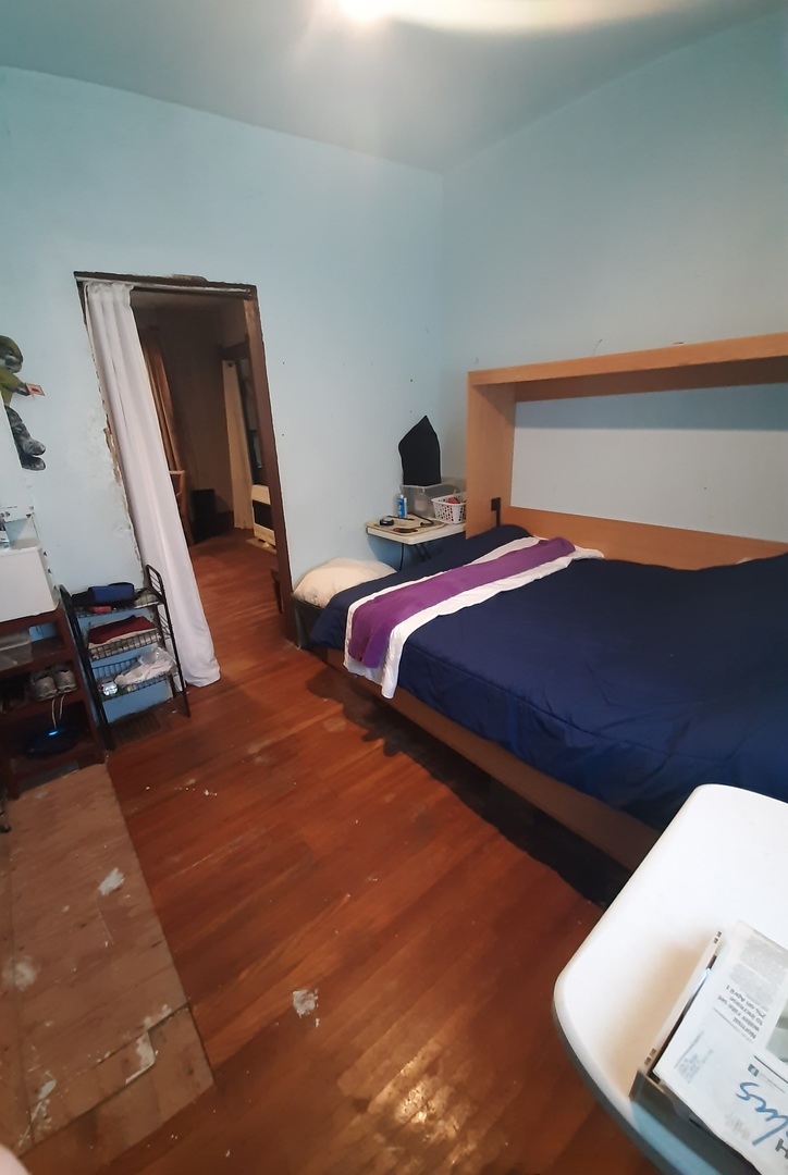 1402 South Wright Street Bloomington, IL 61701 - Photo 15 of 20 a bedroom with bed and wooden floor