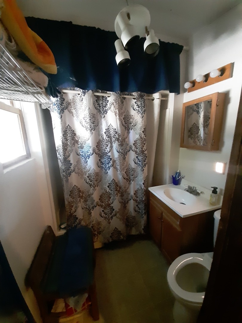 1402 South Wright Street Bloomington, IL 61701 - Photo 17 of 20 a bathroom with a toilet sink and mirror