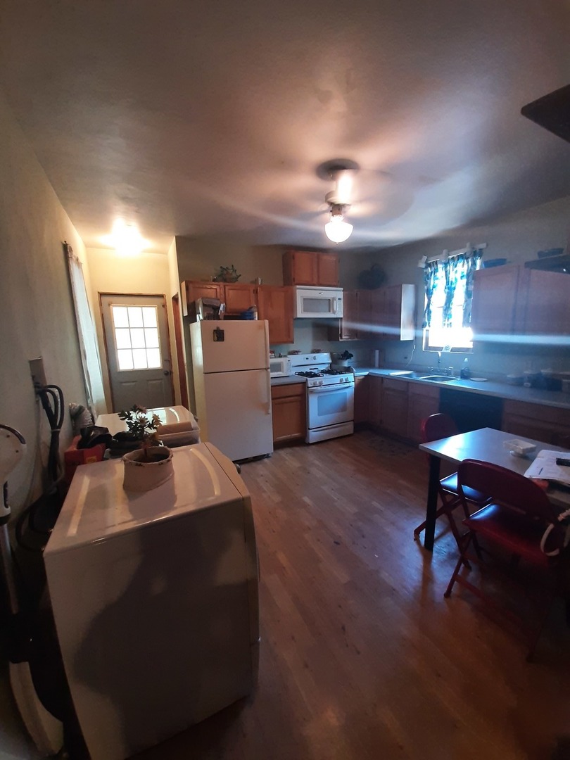 1402 South Wright Street Bloomington, IL 61701 - Photo 18 of 20 a living room with a couch wooden floor and a dining table