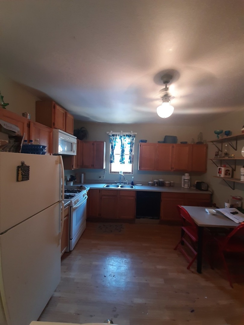 1402 South Wright Street Bloomington, IL 61701 - Photo 19 of 20 a kitchen with refrigerator and cabinets
