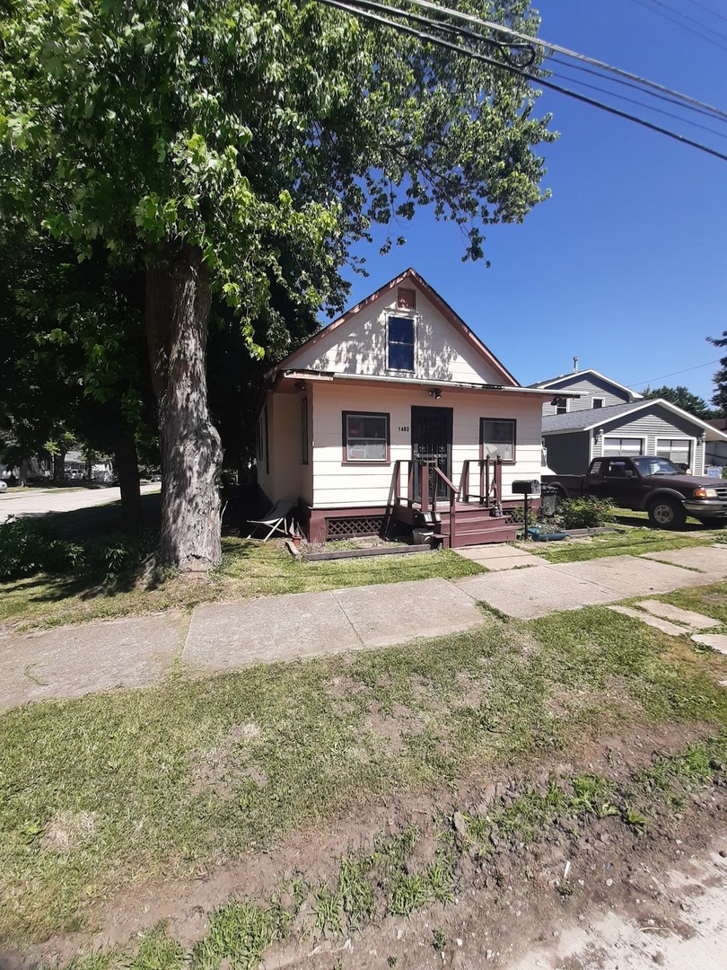 1402 South Wright Street Bloomington, IL 61701 - Photo 2 of 20 a front view of a house with a yard