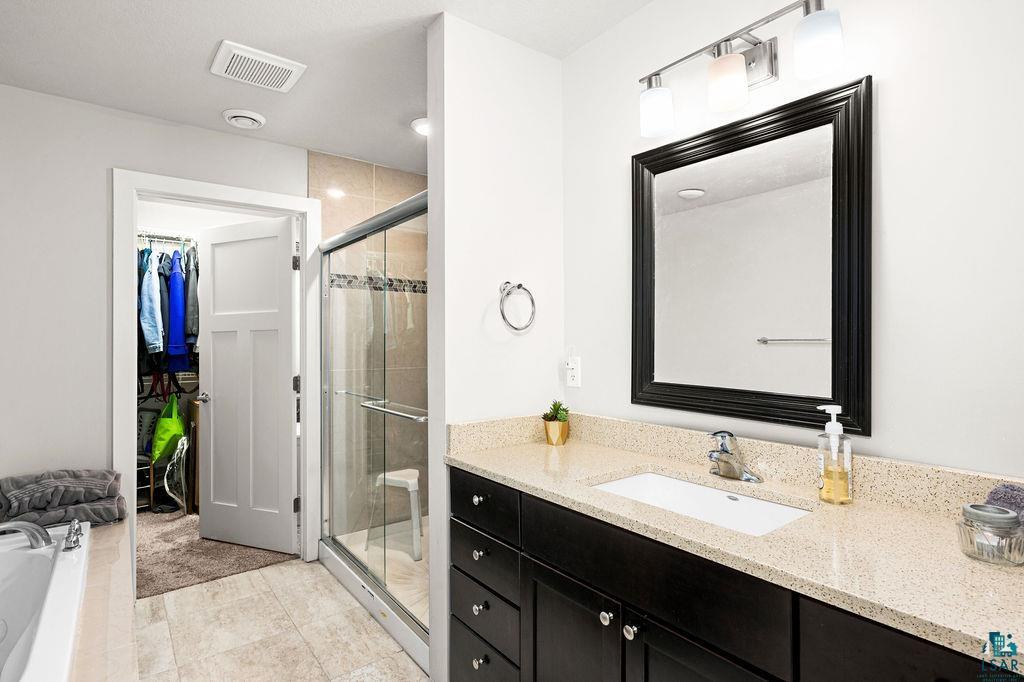 3825 Kenroy Road Hermantown, MN 55811 - Photo 14 of 28 Bathroom with plus walk in shower, tile flooring, and vanity