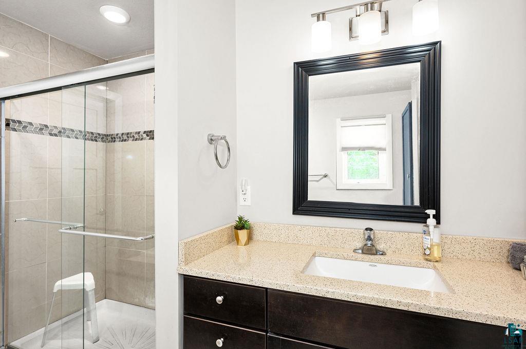3825 Kenroy Road Hermantown, MN 55811 - Photo 16 of 28 Bathroom featuring vanity and a shower with door
