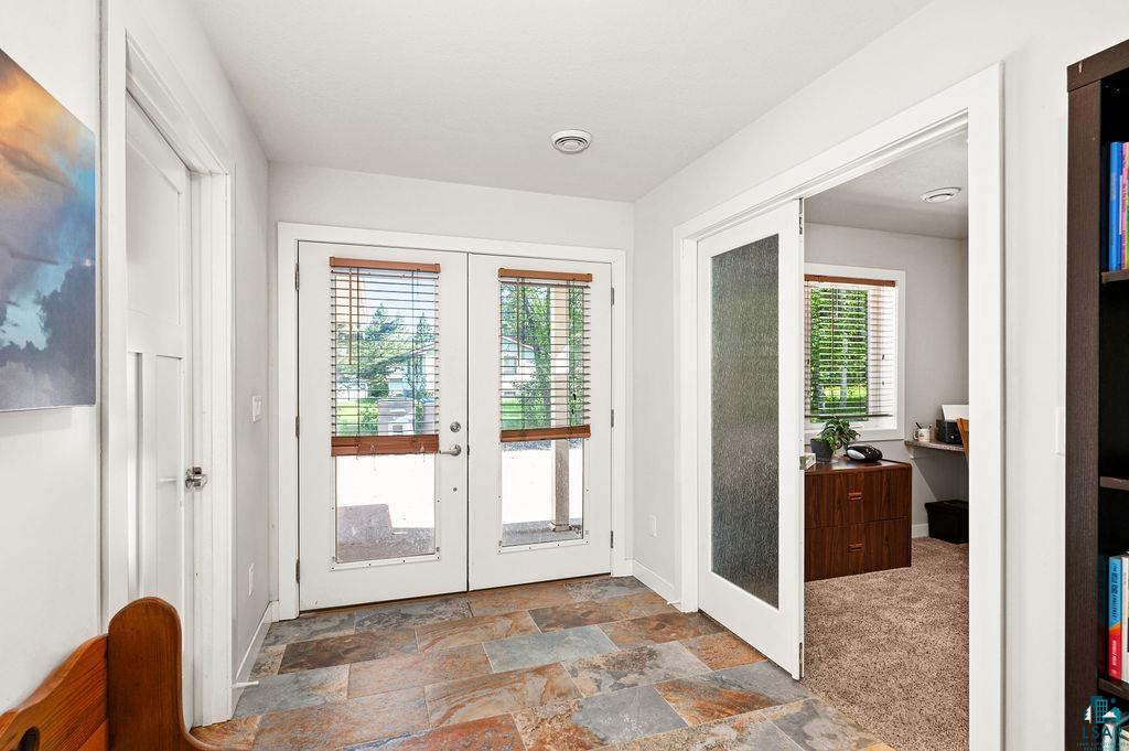 3825 Kenroy Road Hermantown, MN 55811 - Photo 2 of 28 Entryway with french doors, dark tile flooring, and a wealth of natural light