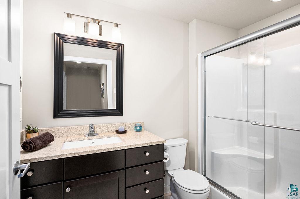 3825 Kenroy Road Hermantown, MN 55811 - Photo 21 of 28 Bathroom with a shower with door, large vanity, and toilet