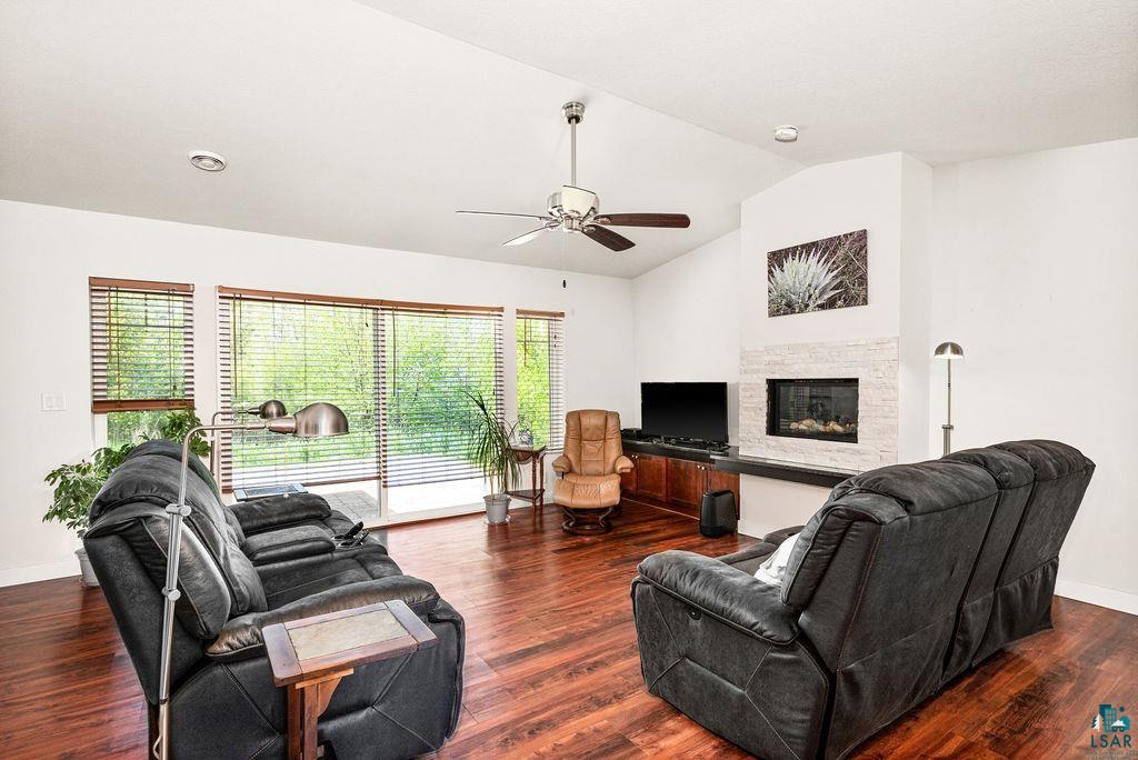 3825 Kenroy Road Hermantown, MN 55811 - Photo 4 of 28 Living room featuring ceiling fan, vaulted ceiling, and dark hardwood / wood-style flooring