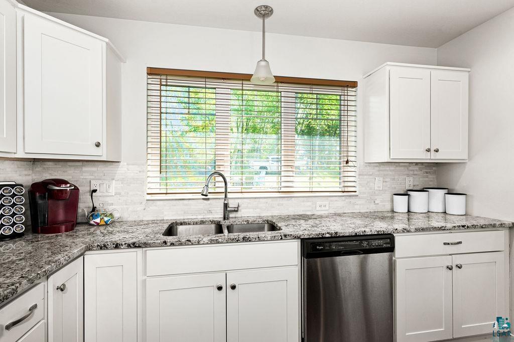 3825 Kenroy Road Hermantown, MN 55811 - Photo 7 of 28 Kitchen with a healthy amount of sunlight, sink, white cabinetry, and stainless steel dishwasher