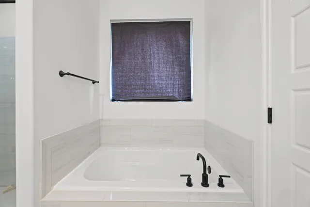 a white bath tub sitting in a bathroom
