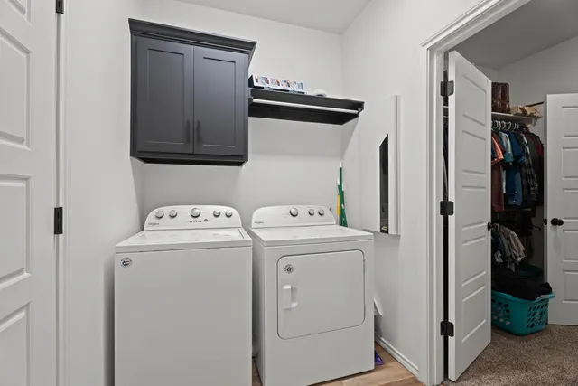 a view of storage and utility room with washer and dryer