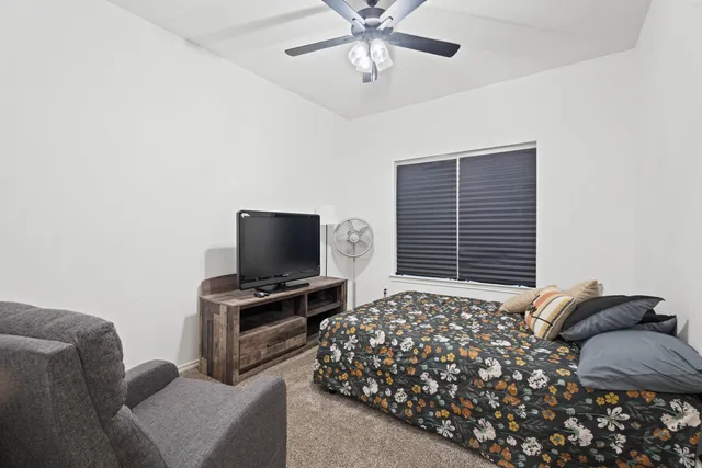 a bedroom with a bed and a television