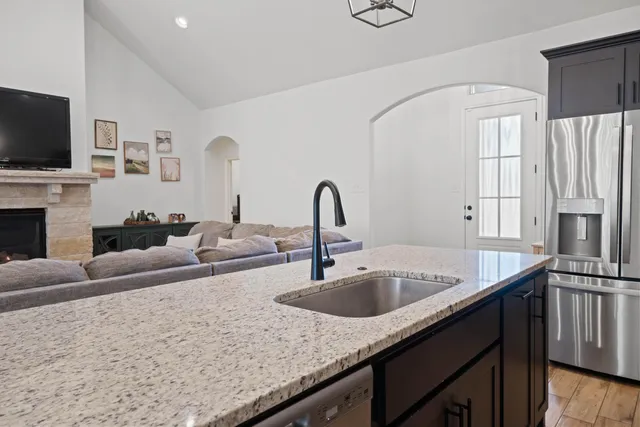 a kitchen with stainless steel appliances granite countertop a sink and a microwave