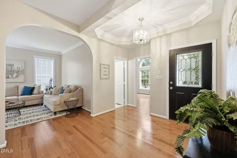 a living room with furniture and a chandelier