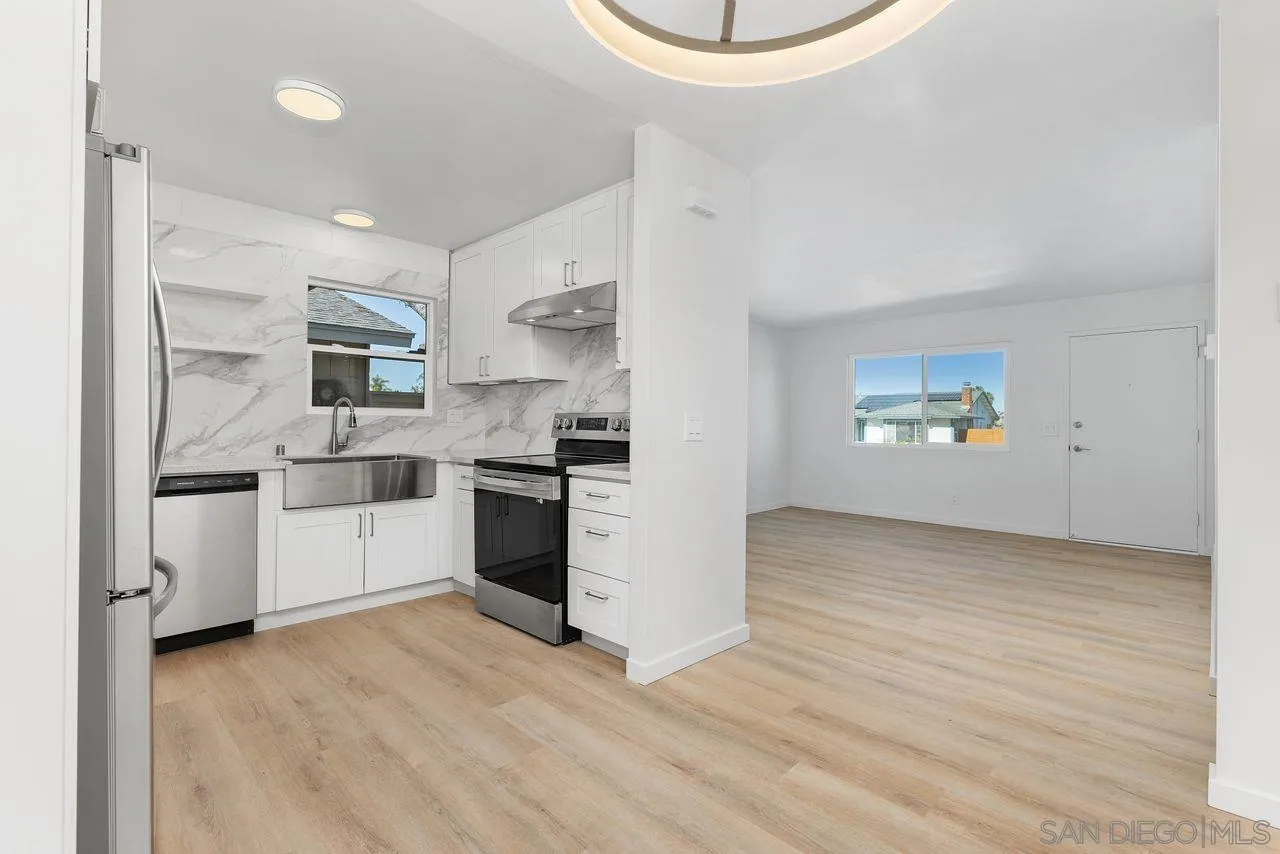 285 Aspenwood Lane Encinitas, CA 92024 - Photo 17 of 39 a kitchen with a white cabinets and white appliances