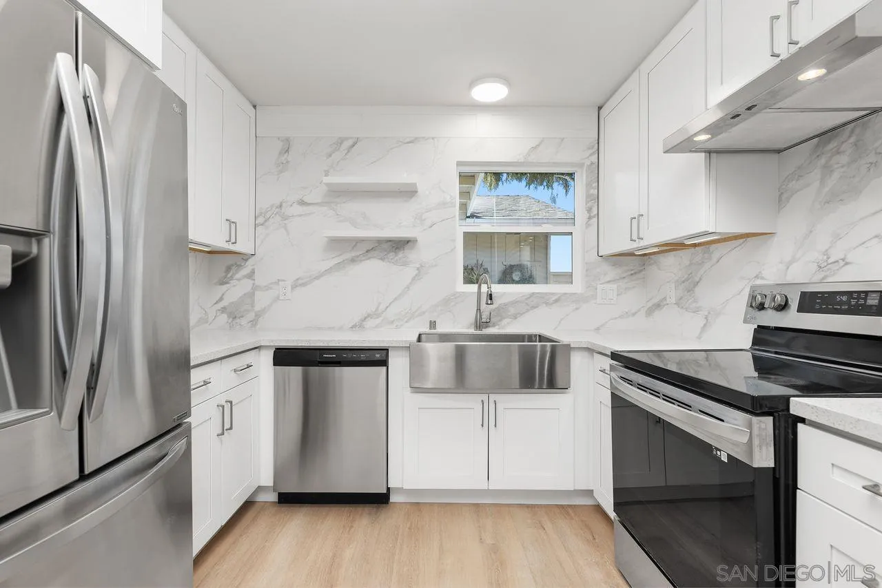 285 Aspenwood Lane Encinitas, CA 92024 - Photo 2 of 39 a kitchen with stainless steel appliances a refrigerator sink and cabinets
