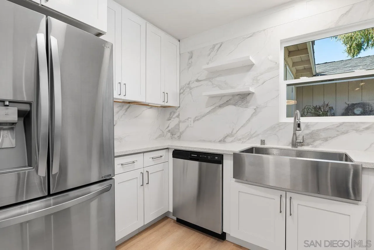 285 Aspenwood Lane Encinitas, CA 92024 - Photo 21 of 39 a kitchen with white cabinets and a refrigerator