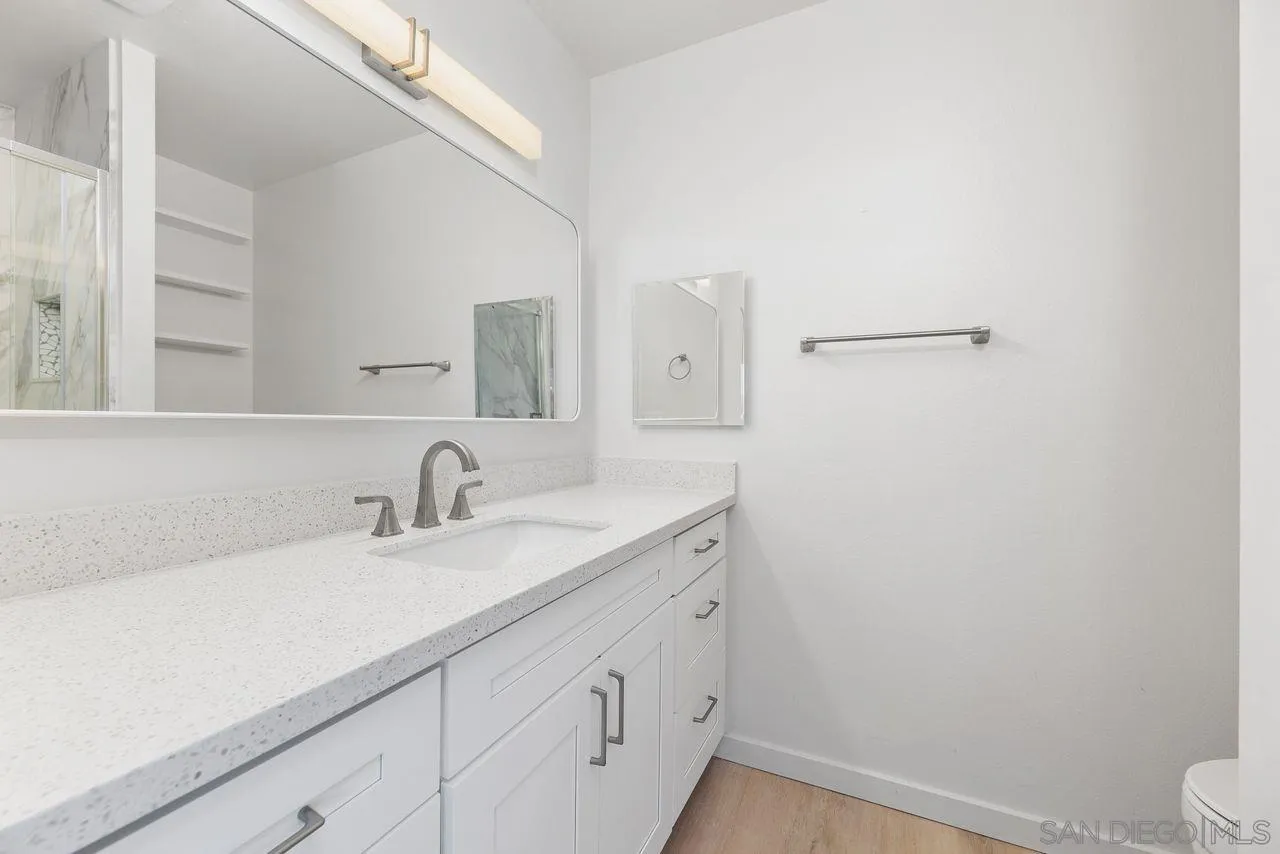 285 Aspenwood Lane Encinitas, CA 92024 - Photo 4 of 39 a bathroom with a sink a toilet and a mirror