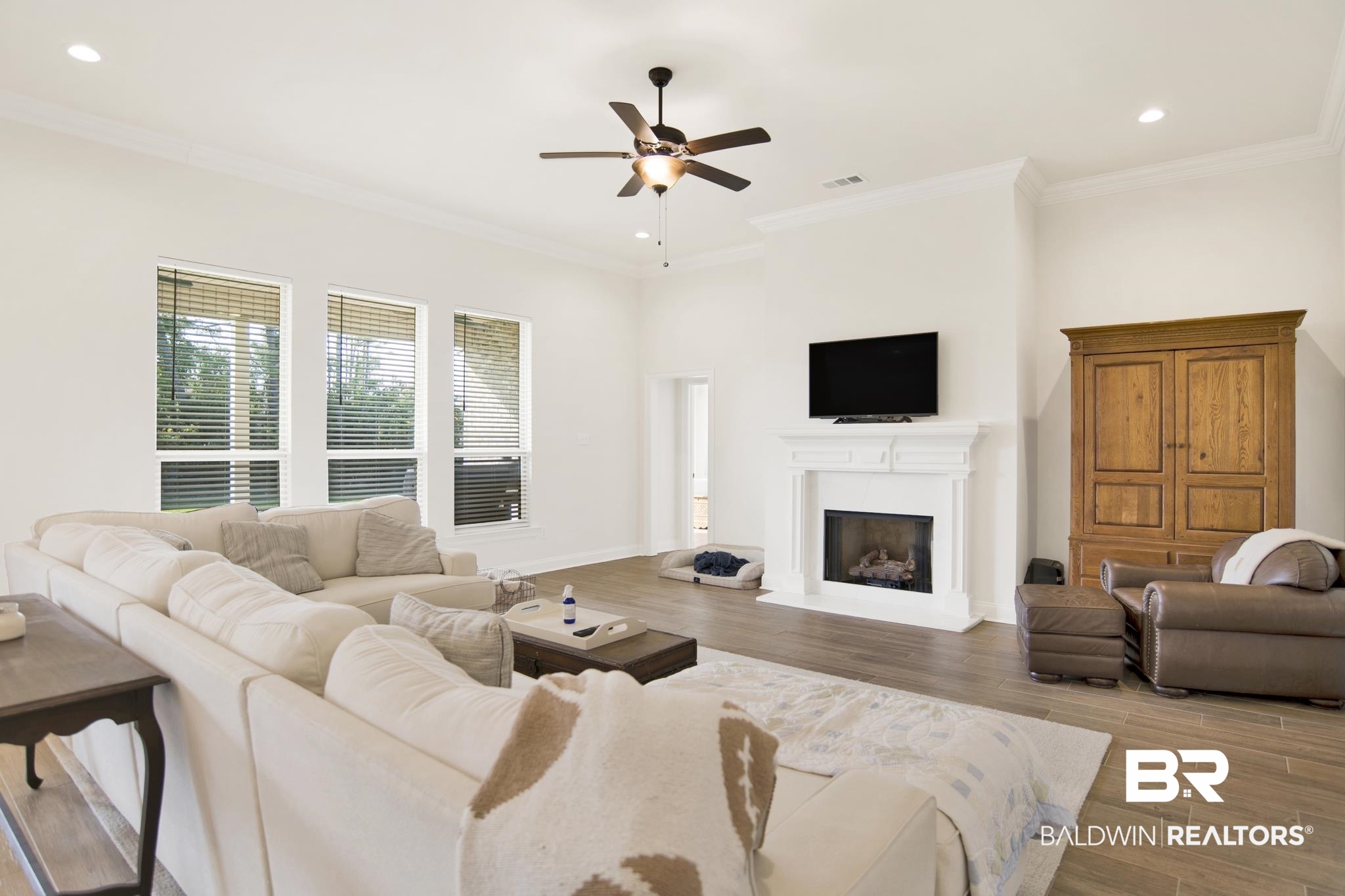 22258 Hibiscus Circle Foley, AL 36535 - Photo 13 of 26 Living area featuring visible vents, ornamental molding, ceiling fan, and wood finished floors