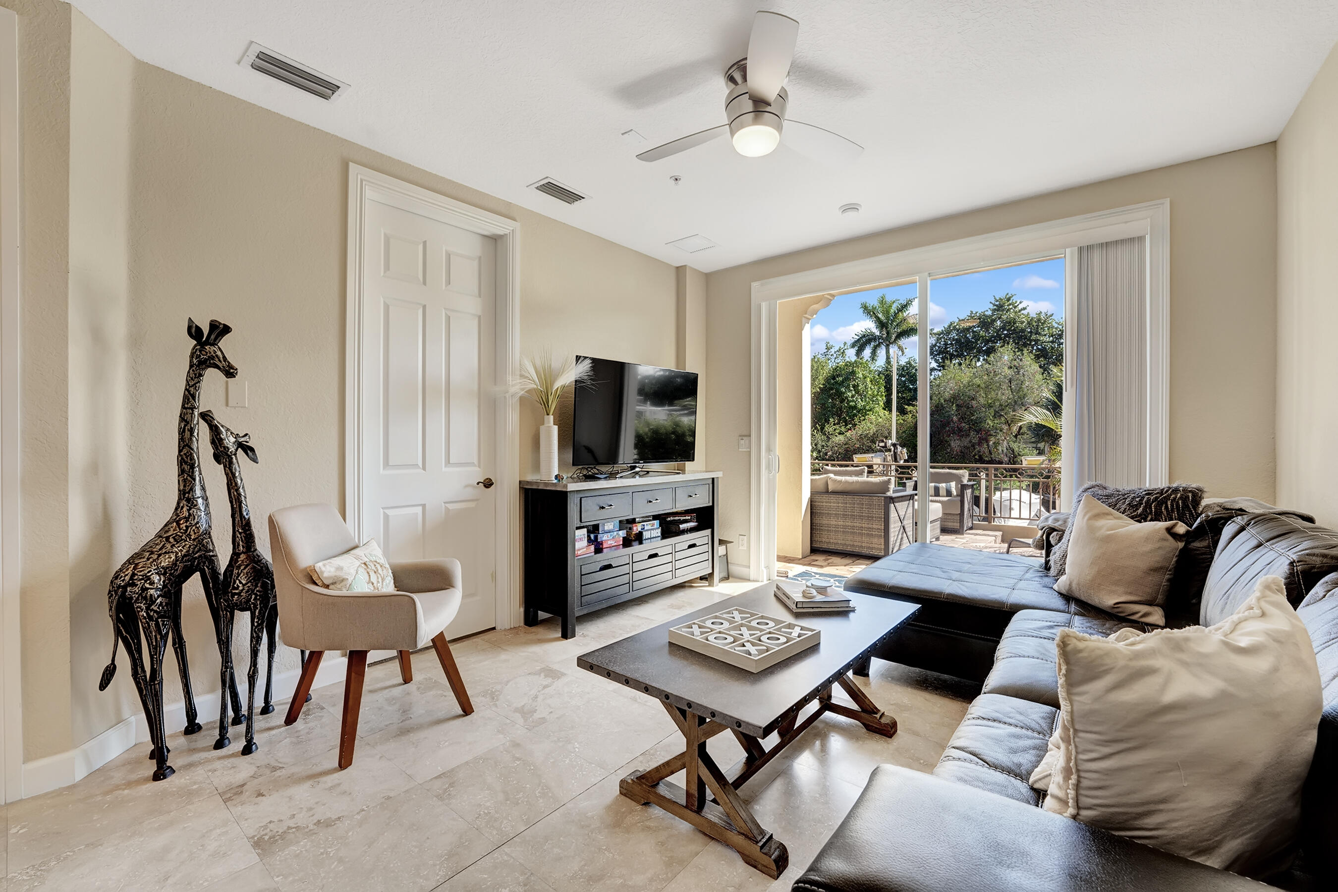 3061 Waterside Circle Boynton Beach, FL 33435 - Photo 12 of 39 a living room with furniture a flat screen tv and a large window