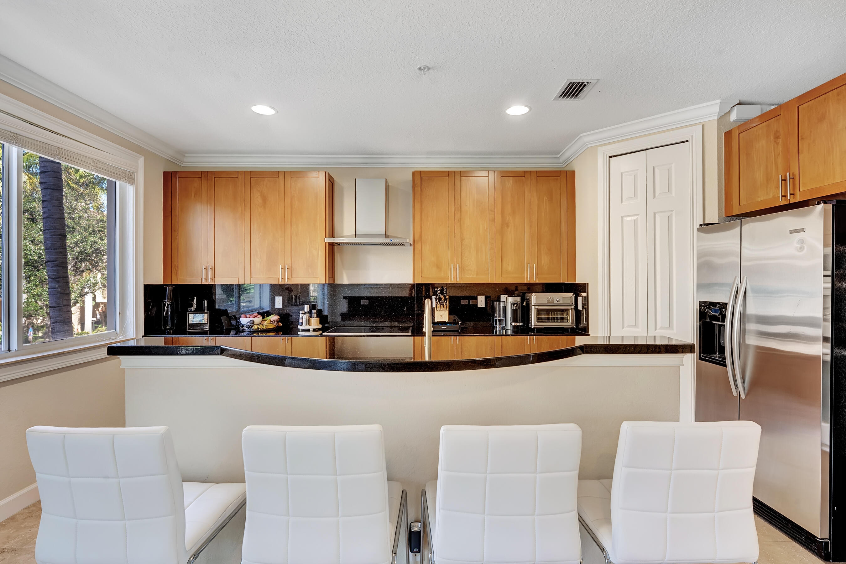 3061 Waterside Circle Boynton Beach, FL 33435 - Photo 22 of 39 a view of a kitchen with kitchen island a large window cabinets a sink and stainless steel appliances
