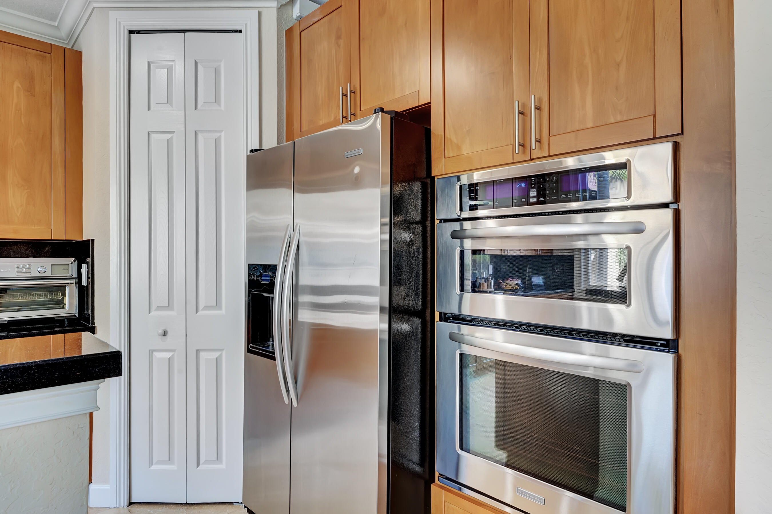 3061 Waterside Circle Boynton Beach, FL 33435 - Photo 23 of 39 a kitchen with cabinets and stainless steel appliances