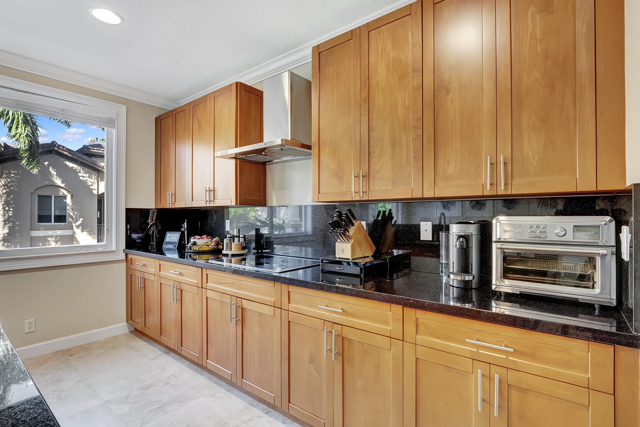 3061 Waterside Circle Boynton Beach, FL 33435 - Photo 25 of 39 a kitchen with stainless steel appliances granite countertop a stove a sink and a microwave