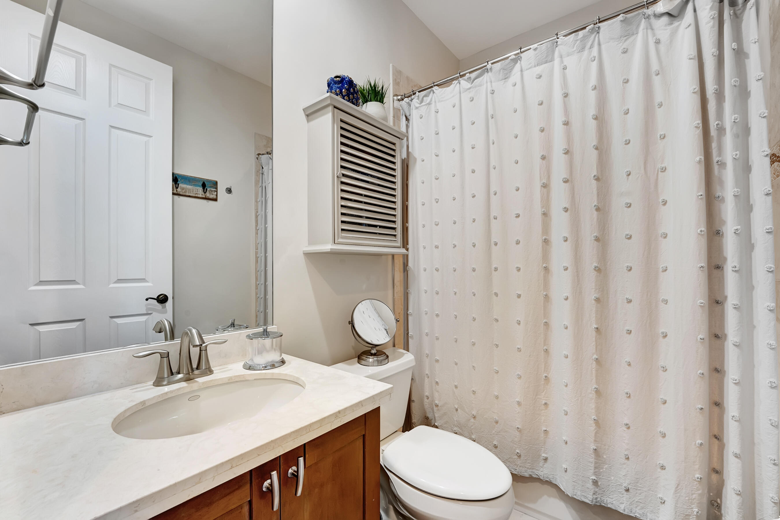 3061 Waterside Circle Boynton Beach, FL 33435 - Photo 34 of 39 a bathroom with a sink a toilet and shower curtain