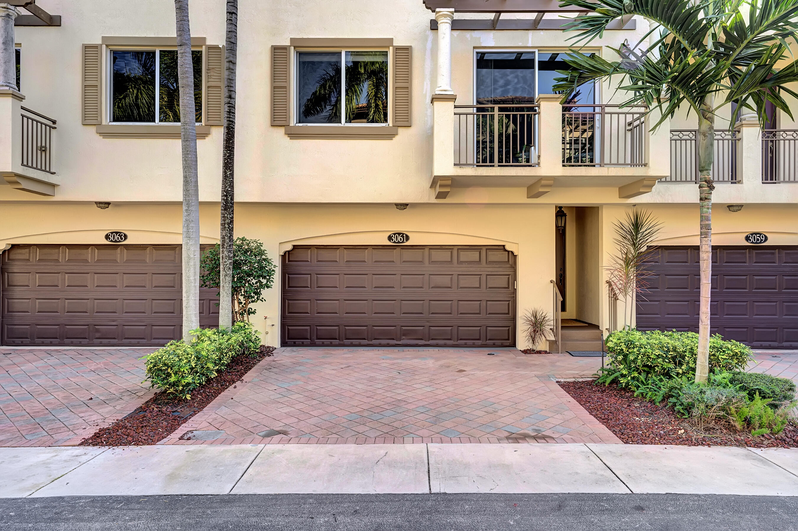 3061 Waterside Circle Boynton Beach, FL 33435 - Photo 7 of 39 a view of a brick house with potted plants and a large tree